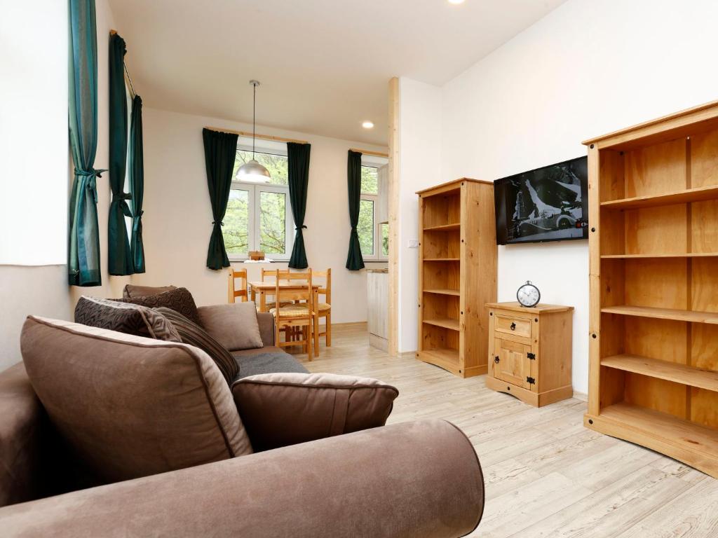 uma sala de estar com um sofá e uma mesa em Apartment Rašeliniště by Interhome em Desná