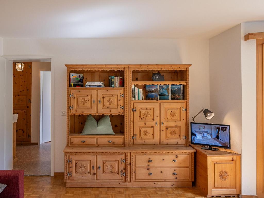 a large wooden cabinet in the corner of a room at Apartment Chesa Muntarütsch by Interhome in Samedan