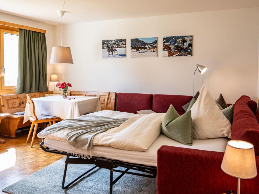 a living room with a couch and a table at Apartment Chesa Muntarütsch by Interhome in Samedan