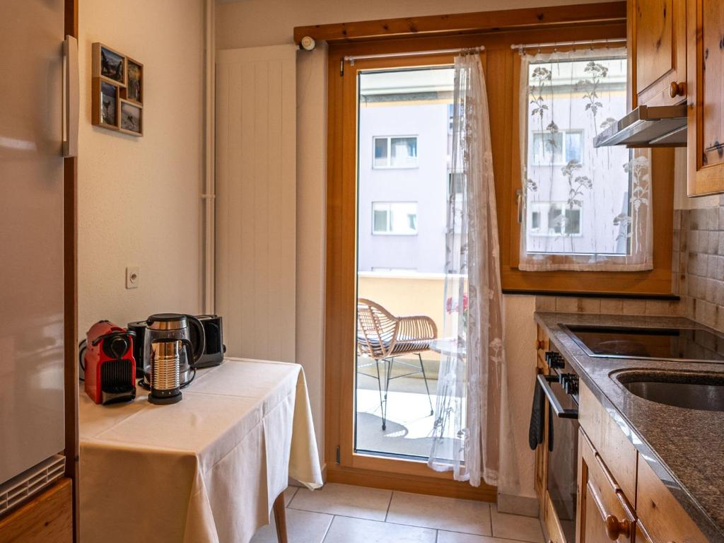 a kitchen with a table with a appliance on it at Apartment Chesa Muntarütsch by Interhome in Samedan