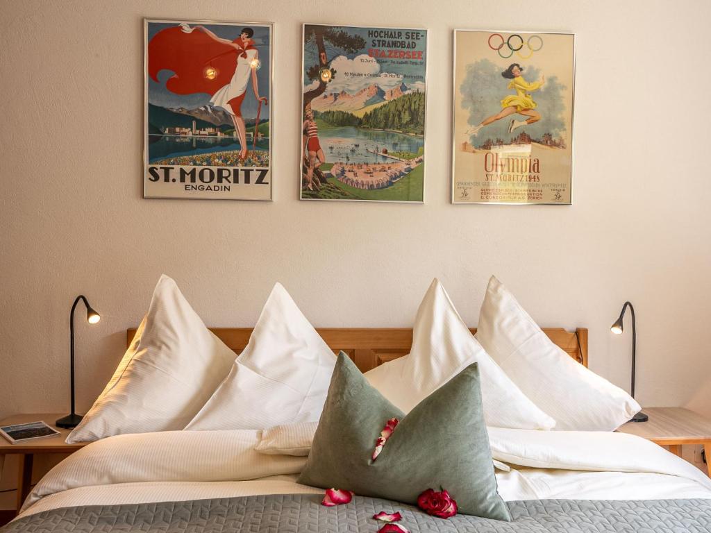 a bedroom with posters on the wall and a bed with pillows at Apartment Chesa Muntarütsch by Interhome in Samedan