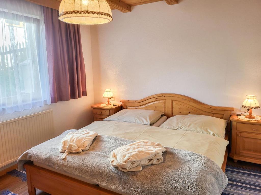 a bedroom with a bed and two lamps and a window at Apartment Sonnenschein B by Interhome in Spiss