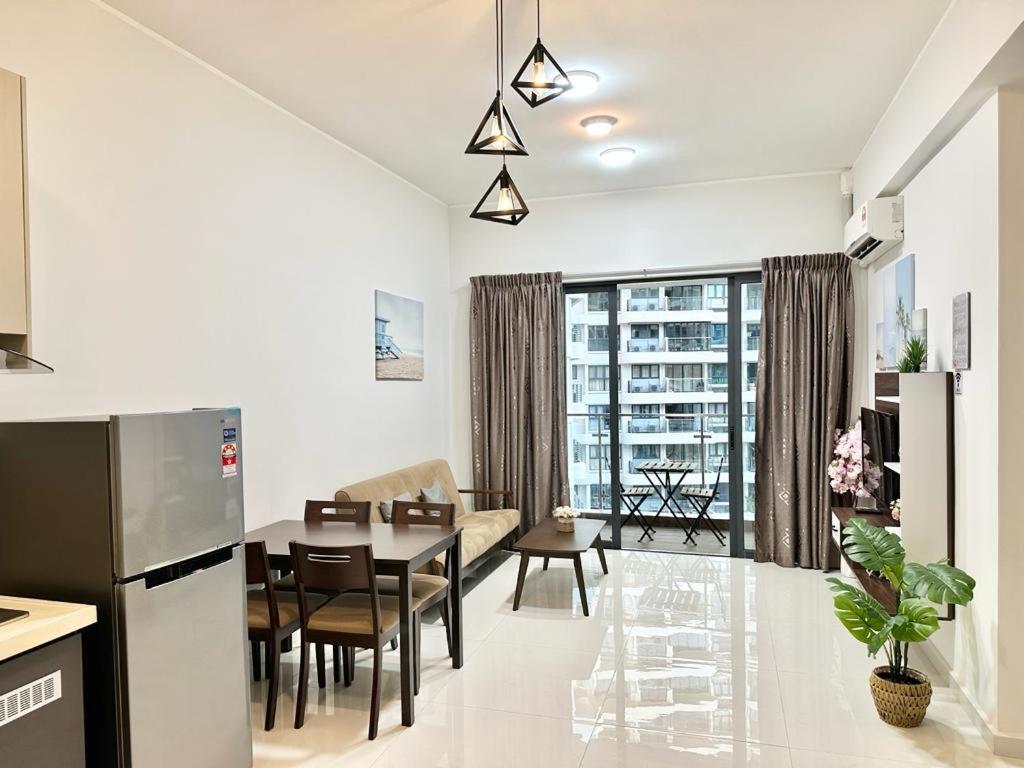 a kitchen and living room with a table and chairs at Country Garden Danga Bay in Johor Bahru