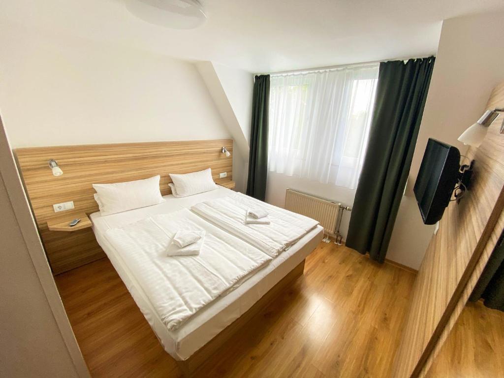 a bedroom with a large bed with white sheets at Limok Rooms Hamm in Hamm