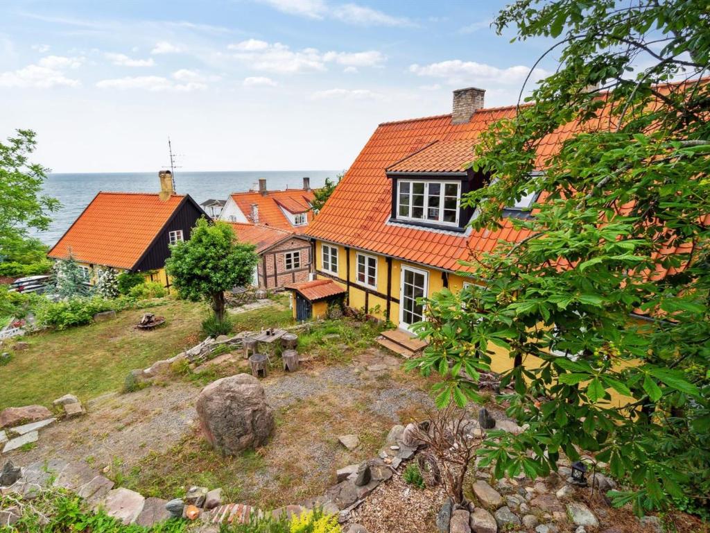 a group of houses on a hill next to the ocean at Apartment Erich - 200m from the sea in Bornholm by Interhome in Hasle
