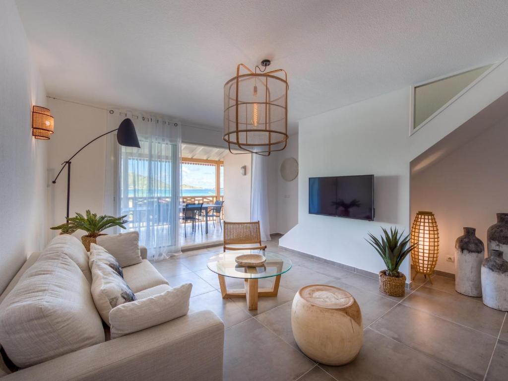 a living room with a couch and a table at Appartement Saint-Martin , 4 pièces, 8 personnes - FR-1-734-2 in Saint Martin