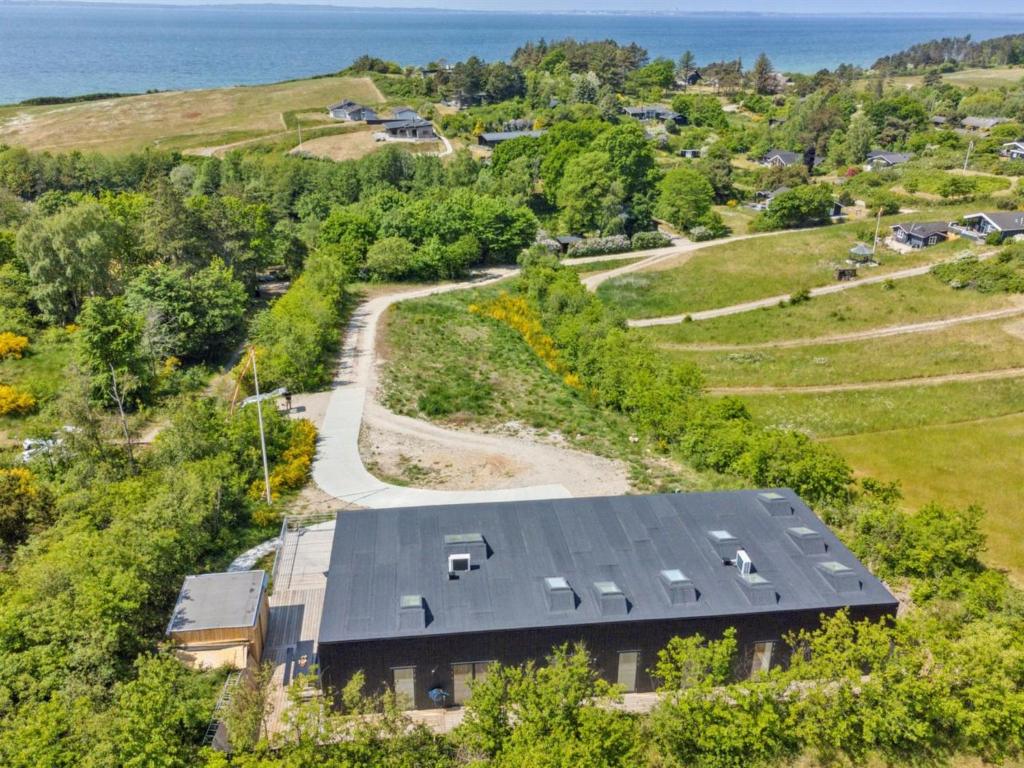an aerial view of a house on a hill with the ocean at Holiday Home Galia - 500m from the sea in Djursland and Mols by Interhome in Ørby