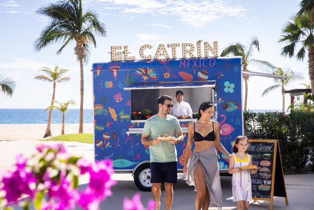 a family walking past an ice cream truck at the beach at Hyatt Ziva Los Cabos - All Inclusive in San José del Cabo
