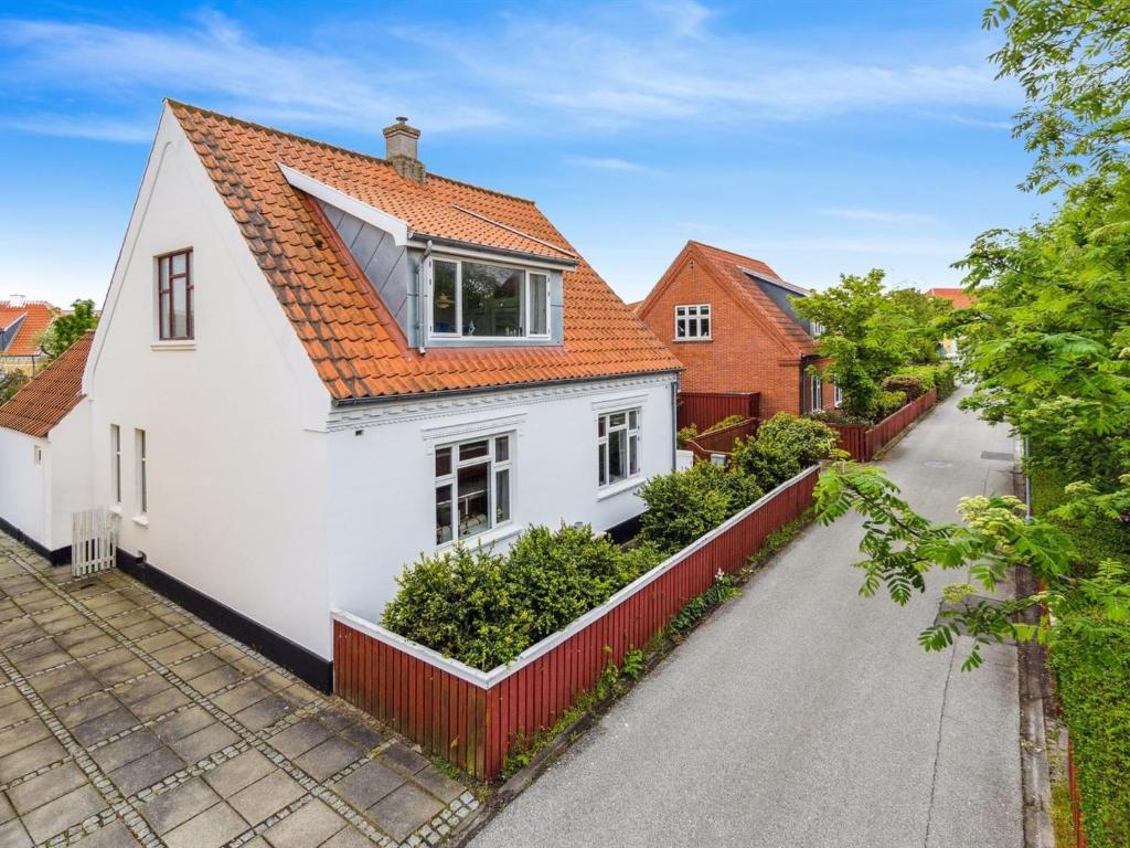 a white house with an orange roof at Holiday Home Cordelia - 1km from the sea in NW Jutland by Interhome in Skagen