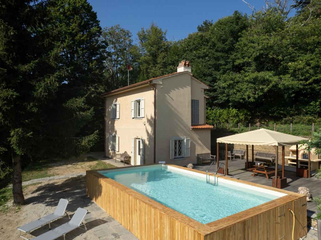 a swimming pool in front of a house at Holiday Home Lucrecia by Interhome in Calci