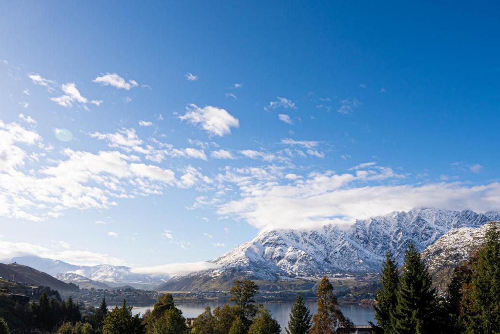 a view of snow covered mountains and a lake at Wild Remarks in Queenstown