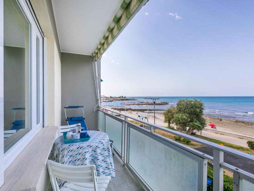 a balcony with a table and a view of the beach at Apartment Massimo Beach House by Interhome in Rosignano Solvay