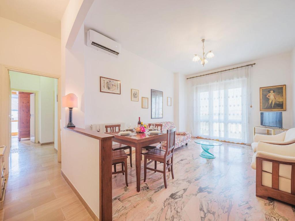a dining room and living room with a table and chairs at Apartment Cinzia by Interhome in Viareggio