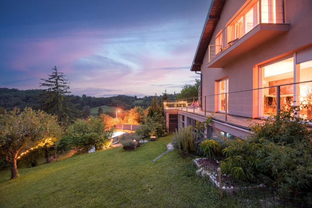 a house with a view of a yard at 3 Bed Villa-Sleeps 8-Private pool-Mountain Views in Kuzminec