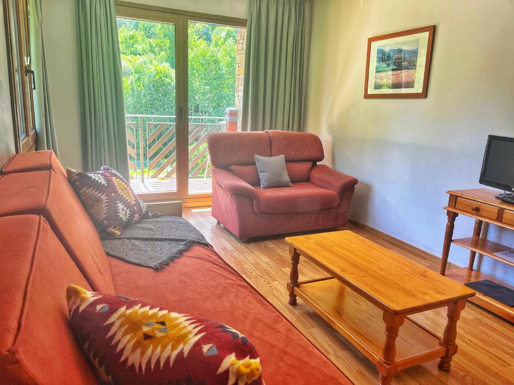 a living room with a couch and a chair at Vista Arinsal Apartments in Arinsal