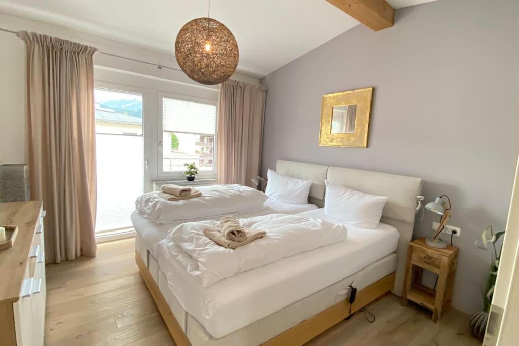 a bedroom with two beds with white sheets at Penthouse in Sonthofen in Sonthofen