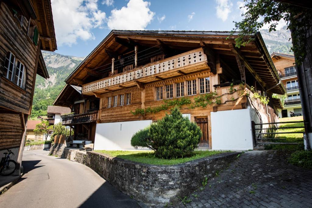 a wooden house with a whiteboard in front of it at Ferienhaus Chalet Oberdorf in Brienz