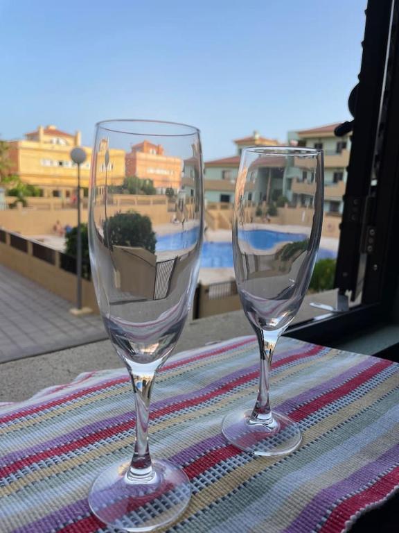 two wine glasses sitting on top of a table at Apartamento La Marquesa Beach in Puertito de Güímar