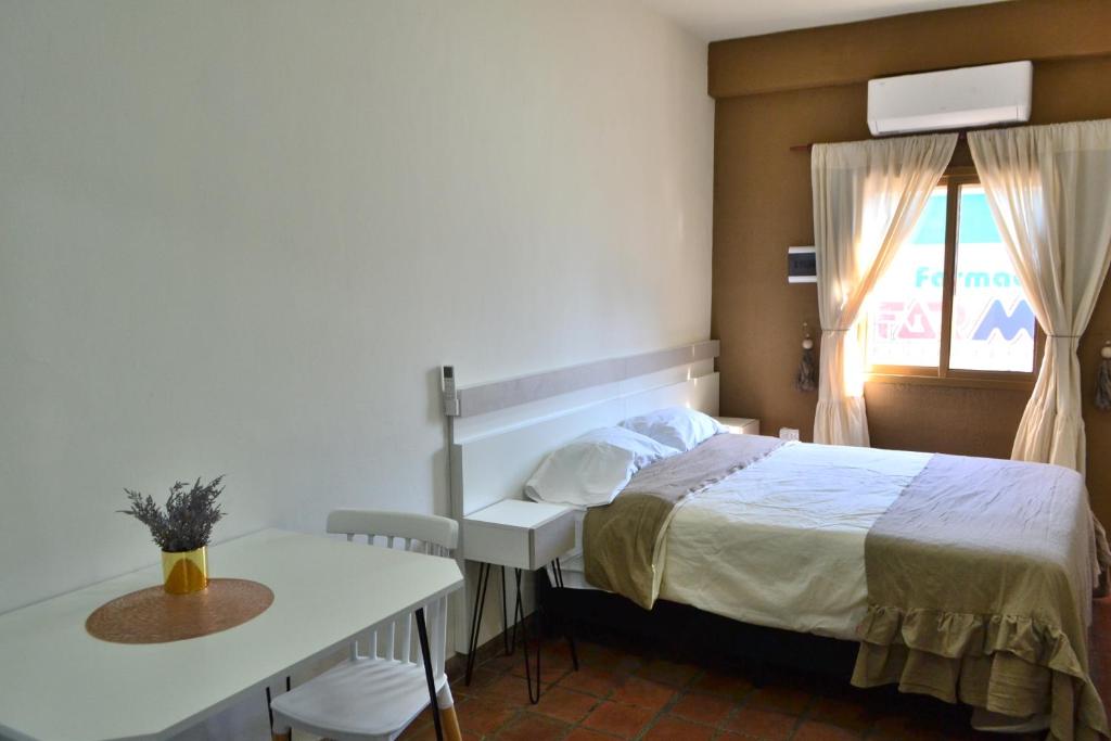 Schlafzimmer mit einem Bett, einem Tisch und einem Fenster in der Unterkunft HANKA in La Rioja