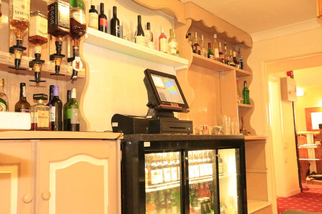 a bar with bottles of alcohol on the wall at One Bedroom Apartment with Balcony at Colliford Tavern & Holiday Site in Bodmin