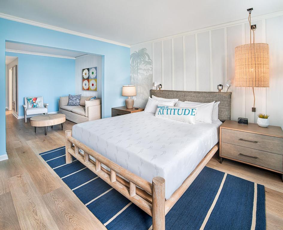 a bedroom with a large bed and a living room at Margaritaville Hotel San Diego Gaslamp Quarter in San Diego