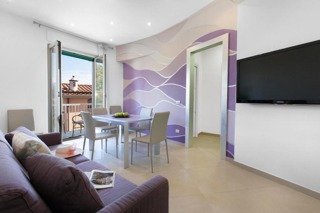 a living room with a couch and a table at Estate4home - L'onda viola in Sorrento