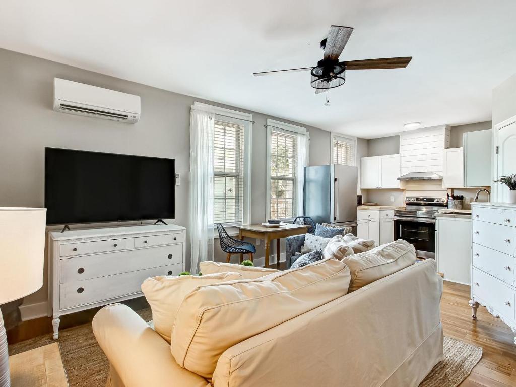 a living room with a couch and a flat screen tv at 7 Seas Unit 4 in Tybee Island