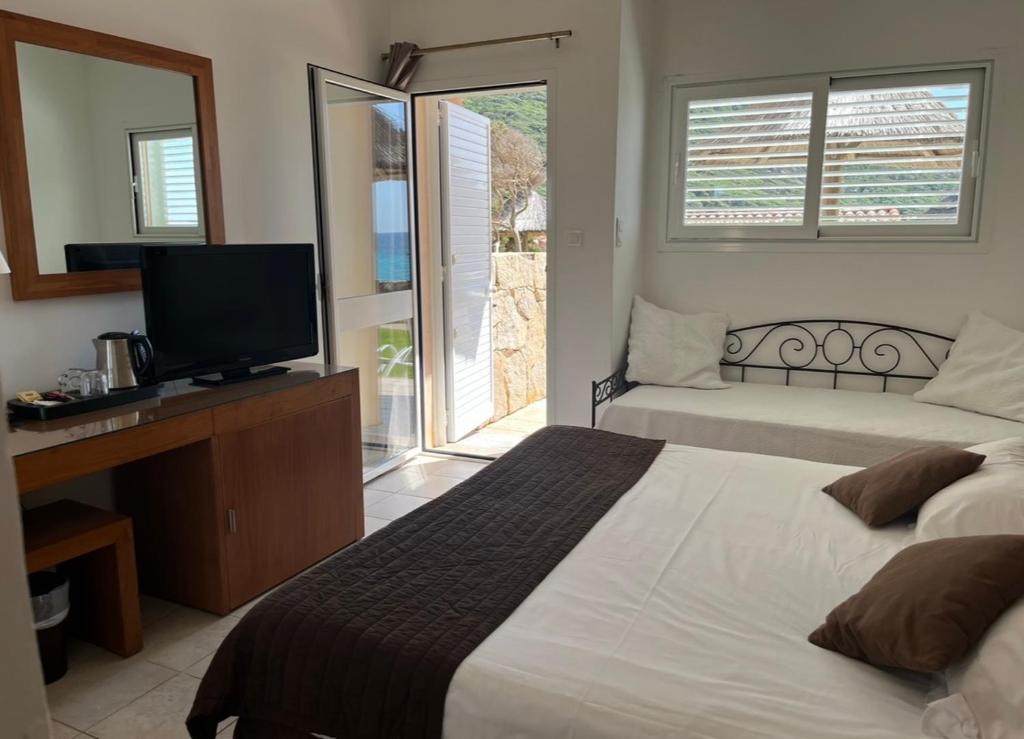 Postel nebo postele na pokoji v ubytování Hôtel Lilium Maris