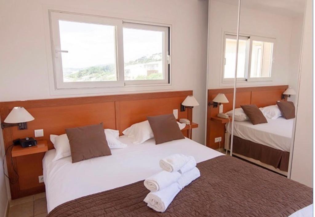 Postel nebo postele na pokoji v ubytování Hôtel Lilium Maris