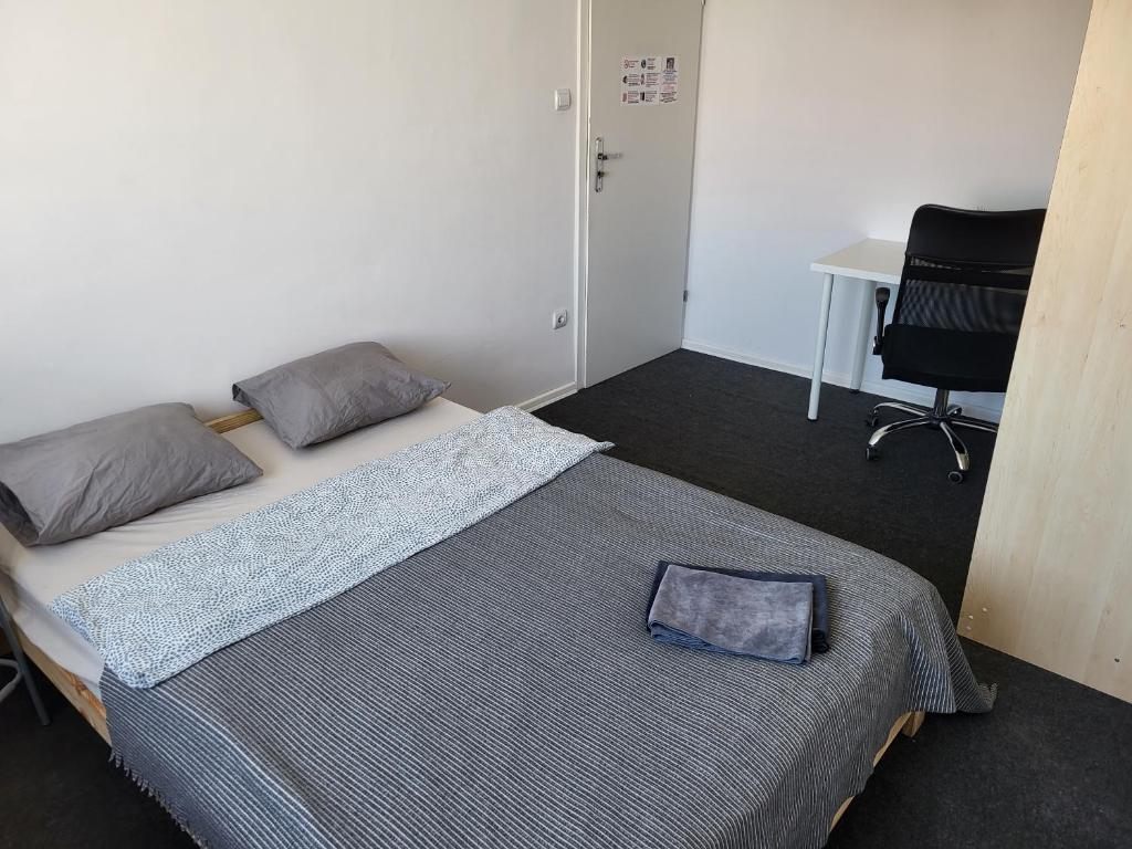 a bedroom with a bed with a laptop on it at Stilo Dom - ul Powstańców Śląskich in Wrocław