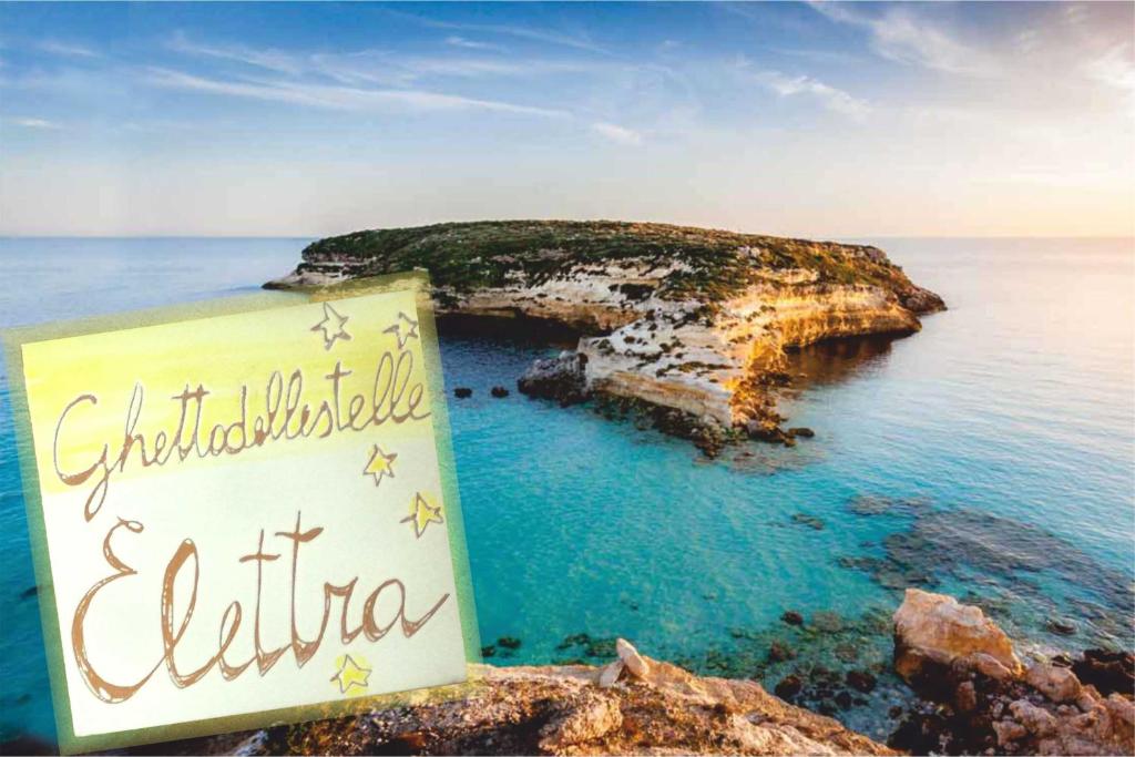 a sign in front of a small island in the ocean at GHETTO DELLE STELLE in Lampedusa