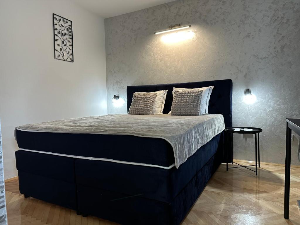 a bedroom with a large bed in a room at Aster Apartments in Belgrade