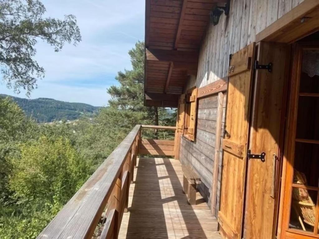 a balcony of a cabin with a view of the mountains at Chalet la parenthèse in Le Tholy