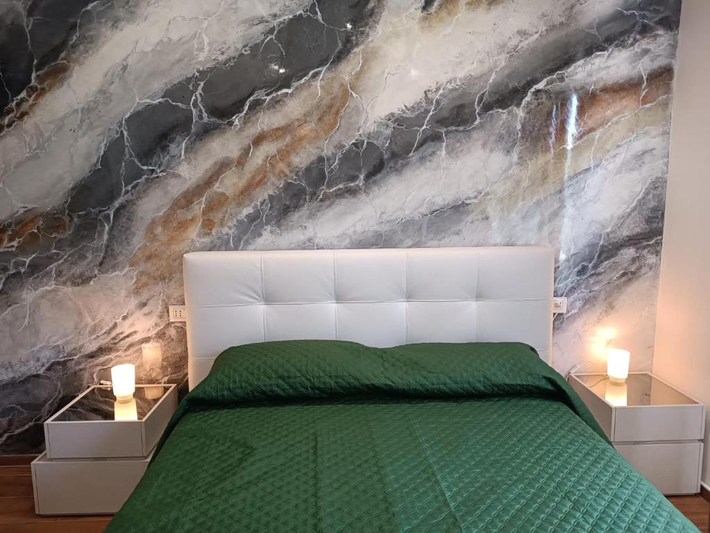 a bedroom with a white bed and a stone wall at 0541 Guest House Rimini in Rimini