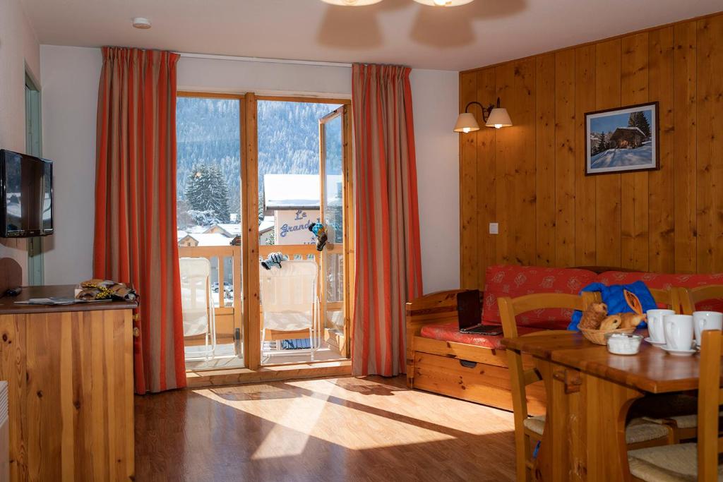 a living room with a couch and a table at Résidence Goélia Le Blanchot in Pralognan-la-Vanoise