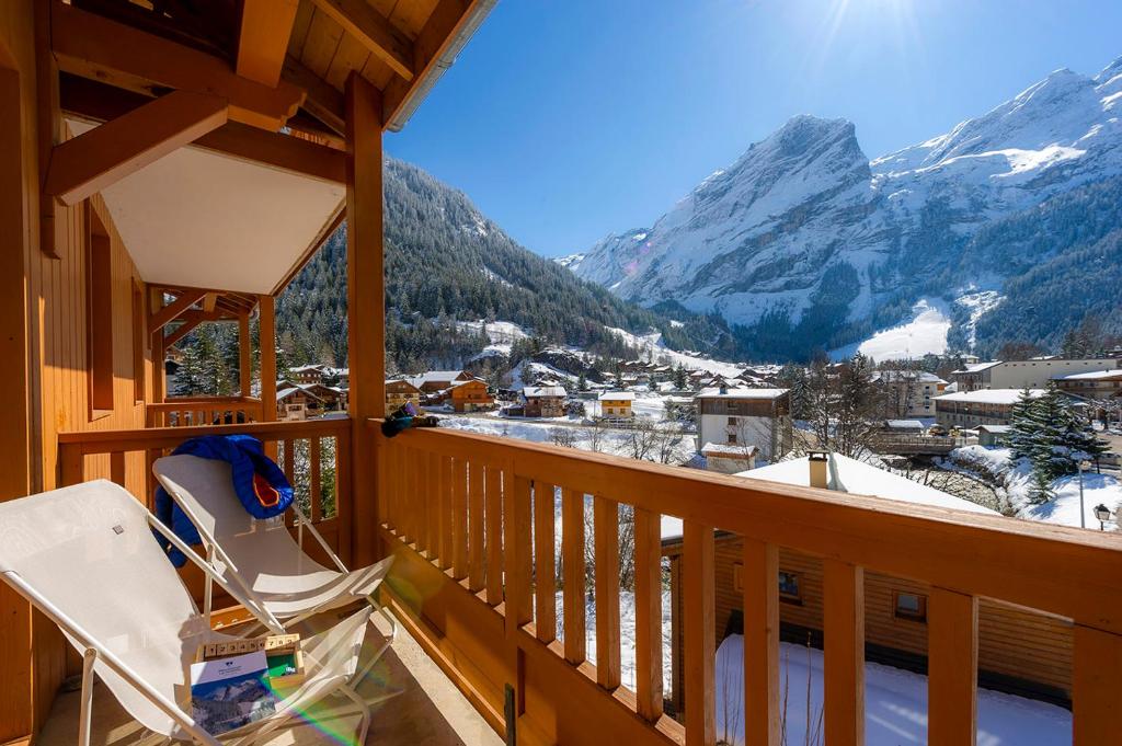 a balcony with a view of a snow covered mountain at Résidence Goélia Le Blanchot in Pralognan-la-Vanoise