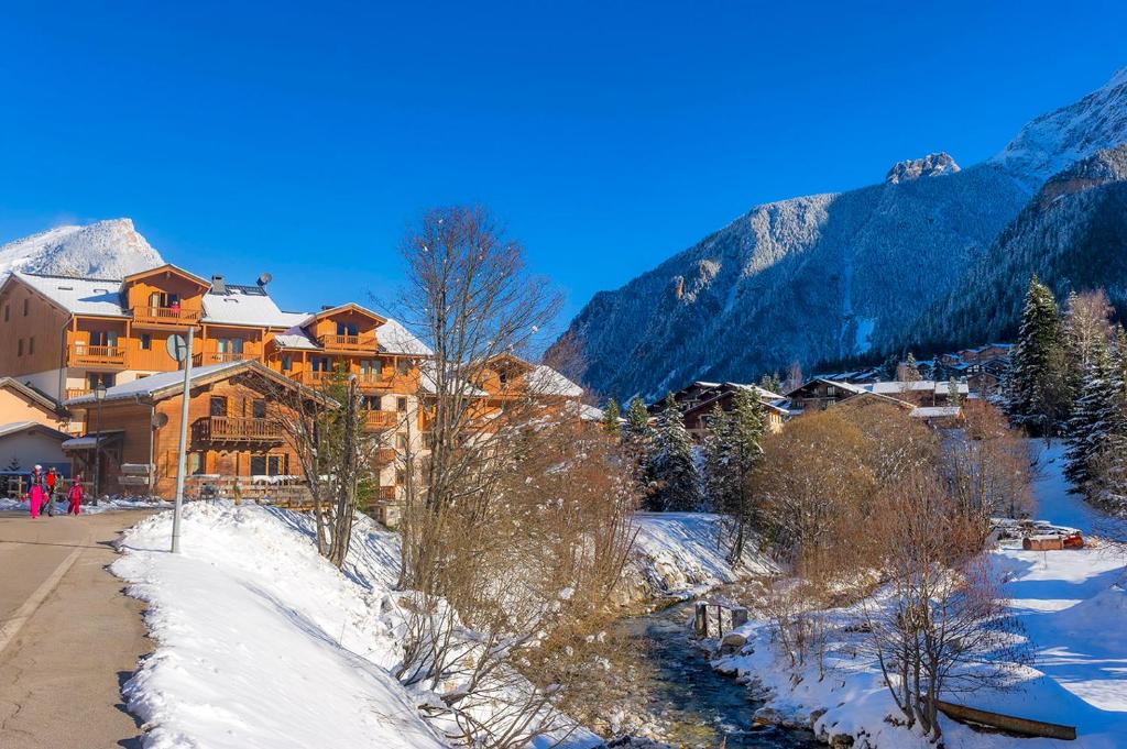 a resort in the mountains with snow on the ground at Résidence Goélia Le Blanchot in Pralognan-la-Vanoise