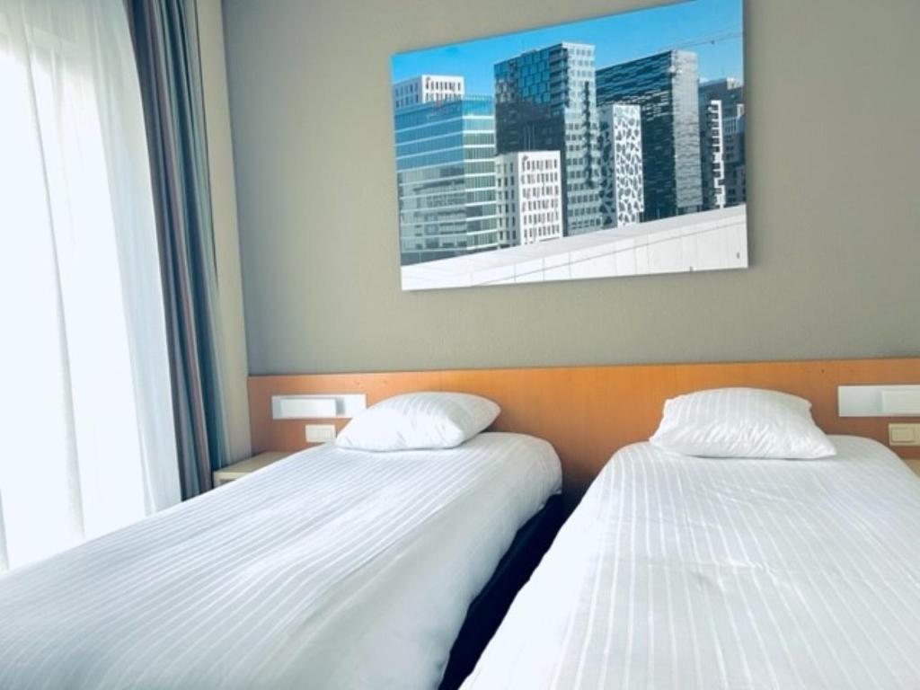 Postel nebo postele na pokoji v ubytování Hobbit Hotel Mechelen