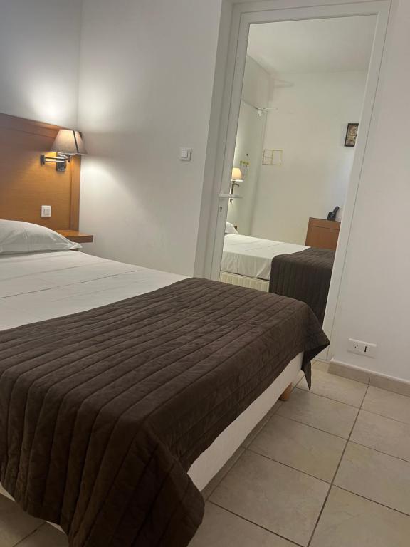 Postel nebo postele na pokoji v ubytování Hôtel Lilium Maris