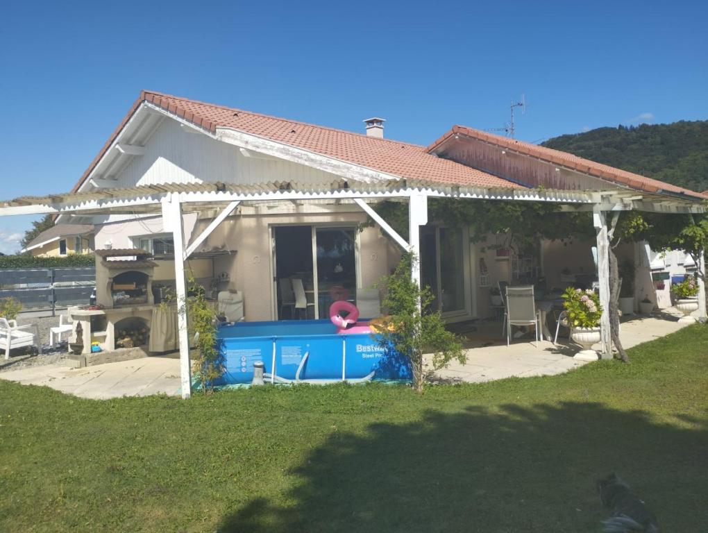 a house with a swimming pool in front of it at Villa Machilly in Machilly
