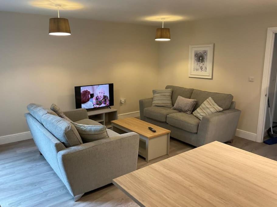 a living room with two couches and a tv at Beautiful Holiday Cottage in Ashbourne