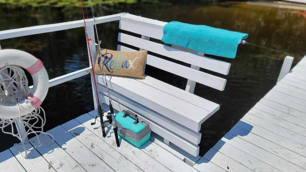 a white bench sitting on a dock with a towel at The Secret Place in Paisley