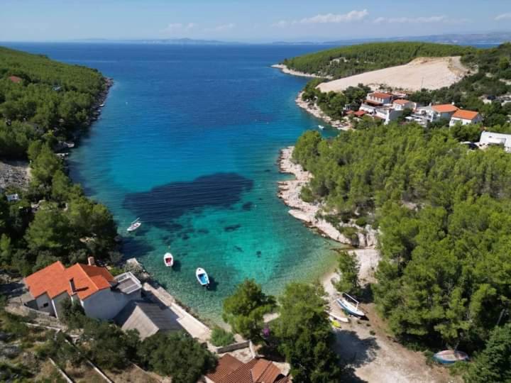 an aerial view of a beach with boats in the water at Primitivo Bay Hvar in Hvar