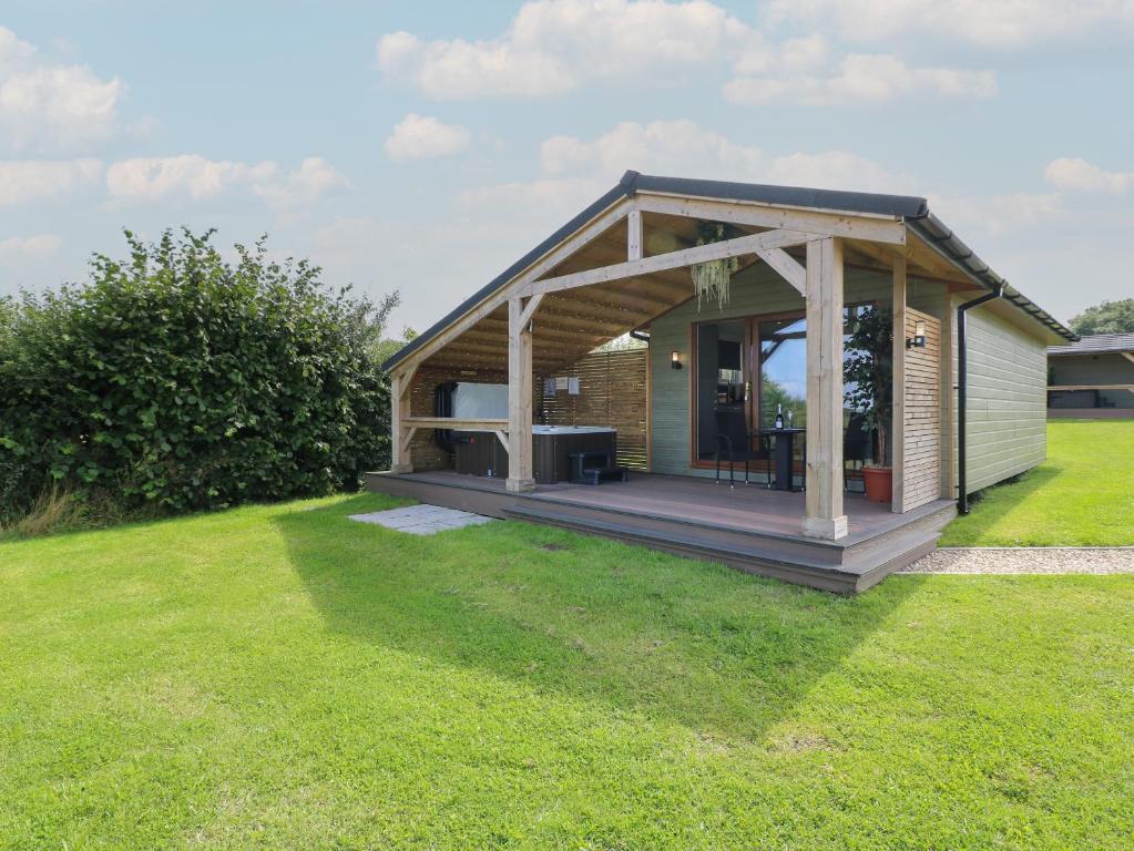 a small house with a porch and a deck at Rowan in Swadlincote