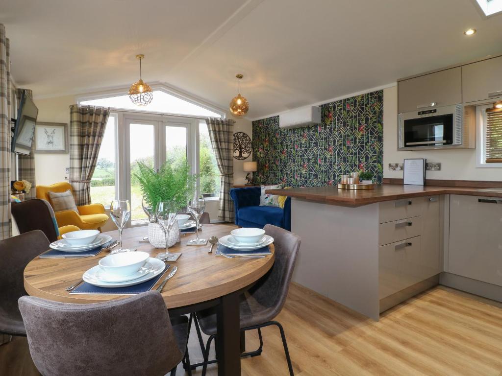 a kitchen and dining room with a table and chairs at Buttercup in Swadlincote