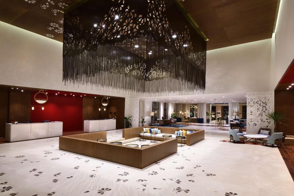 een lobby van een hotel met een grote kamer bij Hilton Taghazout Bay Beach Resort & Spa in Taghazout