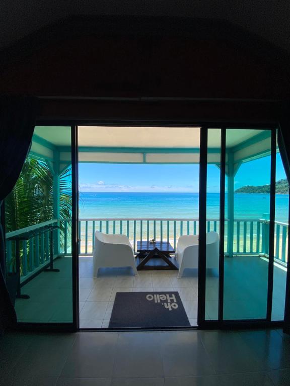 a living room with a view of the ocean at Pondok Beach Shack in Tioman Island
