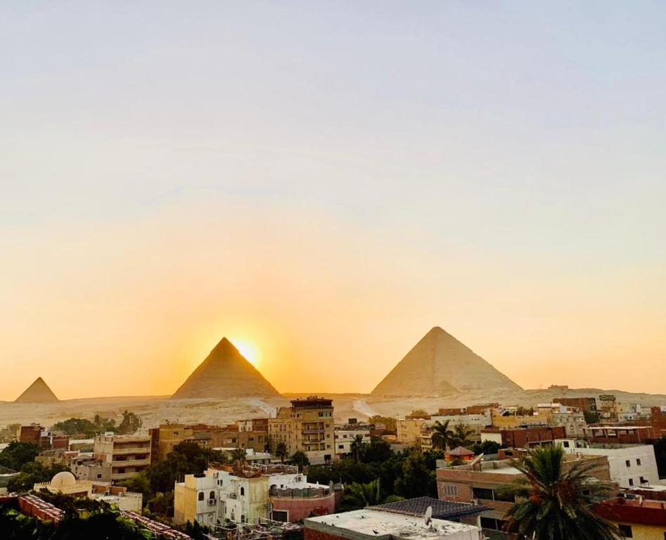 a view of the pyramids of giza at sunset at LOAY PYRAMIDS VIEW in Cairo