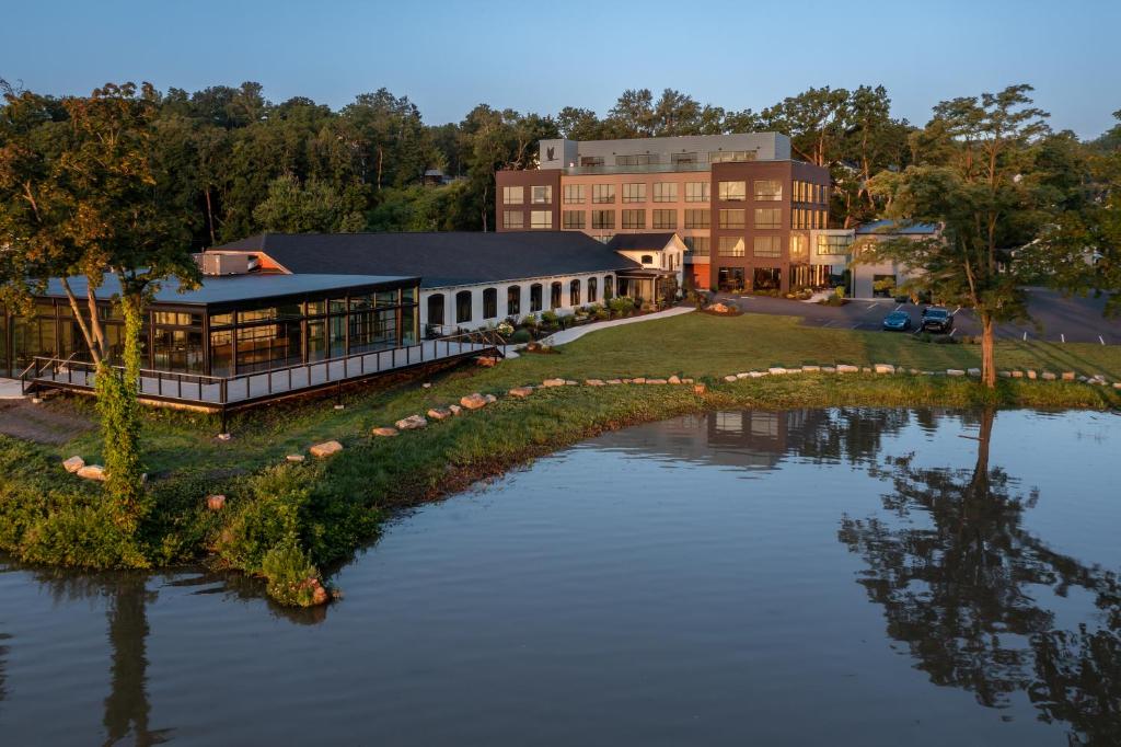 an aerial view of a building next to a body of water at voco James Newbury Hudson Valley, an IHG Hotel in Coxsackie