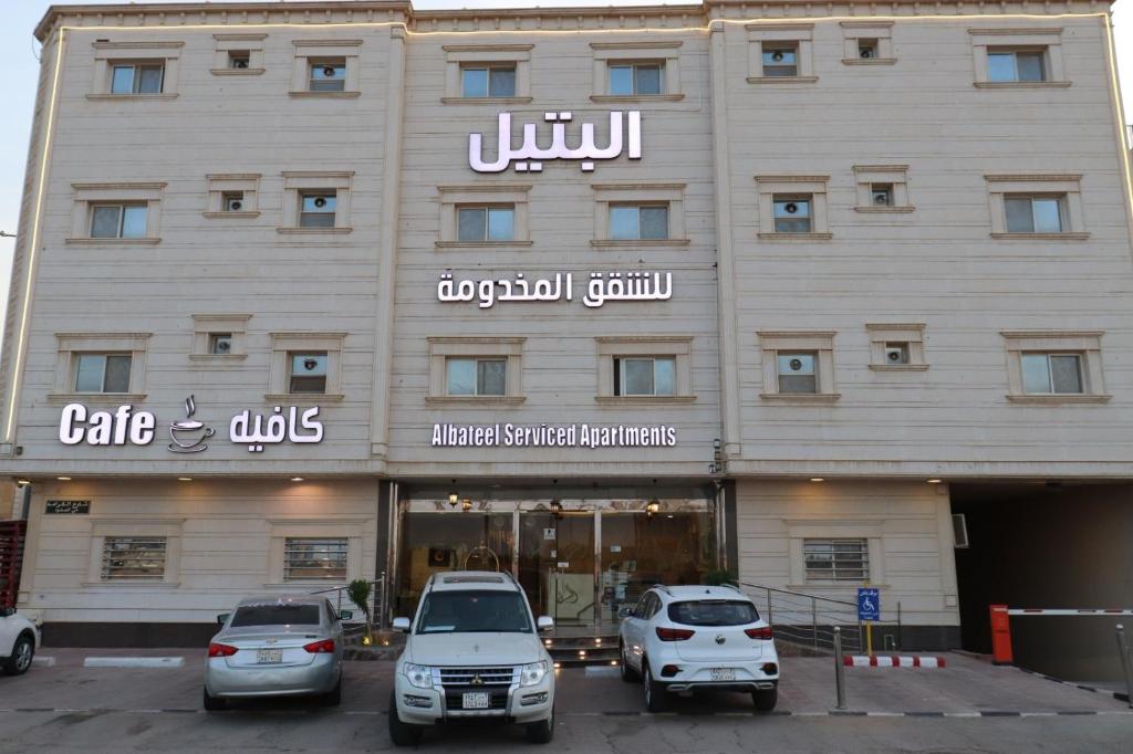 un edificio con coches estacionados frente a él en Al Bateel Furnished Apartments en Riad